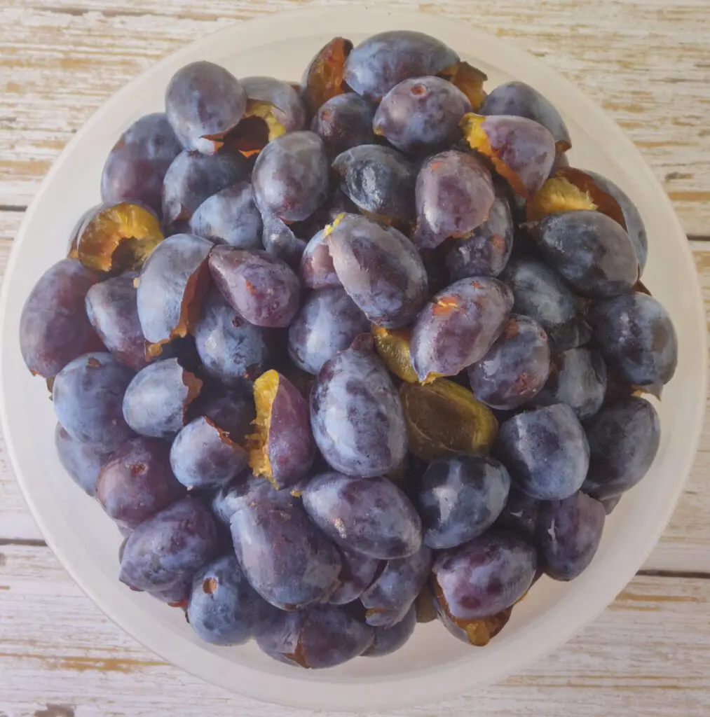 halving the plums and removing the stone