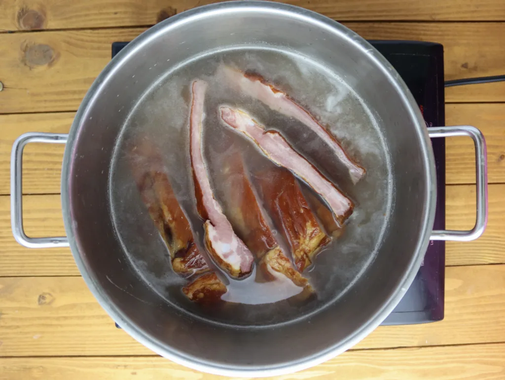 step three: add smoked ribs to barley and cover it with water