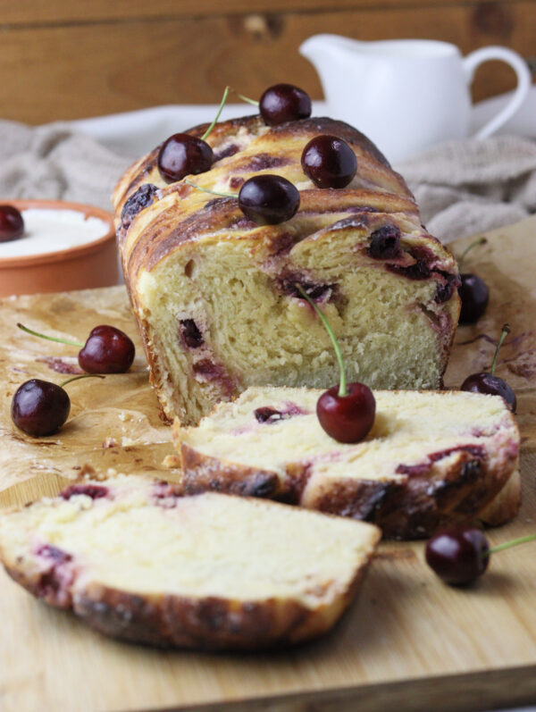 image of baked cherry cheese babka loaf with fresh cherries