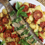 image feauturing baked grey mullet recipe with vegatables and garlic-herb sauce