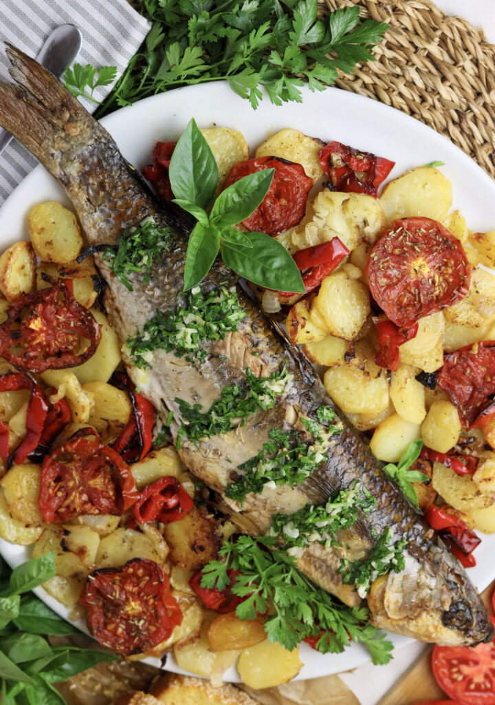 image feauturing baked grey mullet recipe with vegatables and garlic-herb sauce