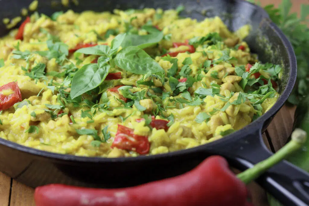 one pot chicken curry and rice served with a red bell pepper