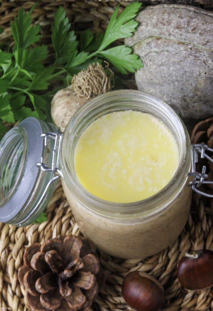 image of a jar with saffron milk cap pate topped with a layer of butter 