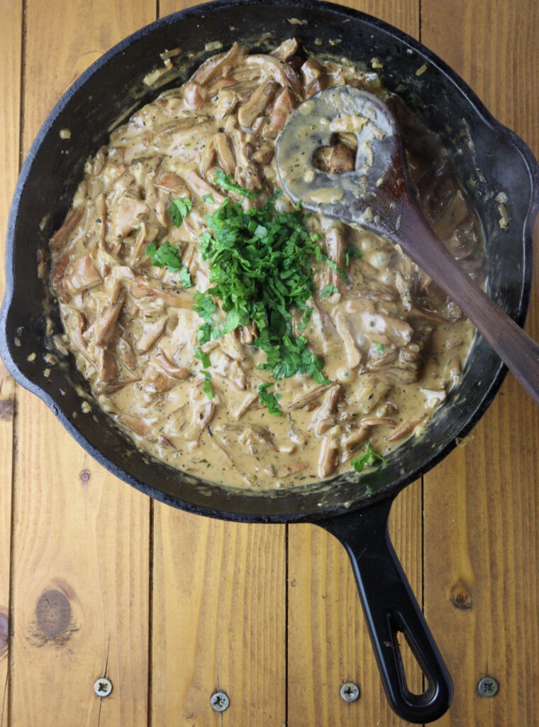 image of adding fresh chopped parsley to the pan 